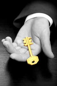 Businessman holding the business gold key